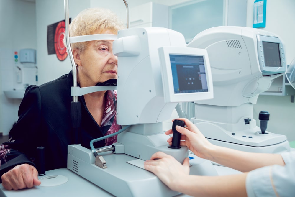 Elderly woman getting eye exam to evaluate cataracts